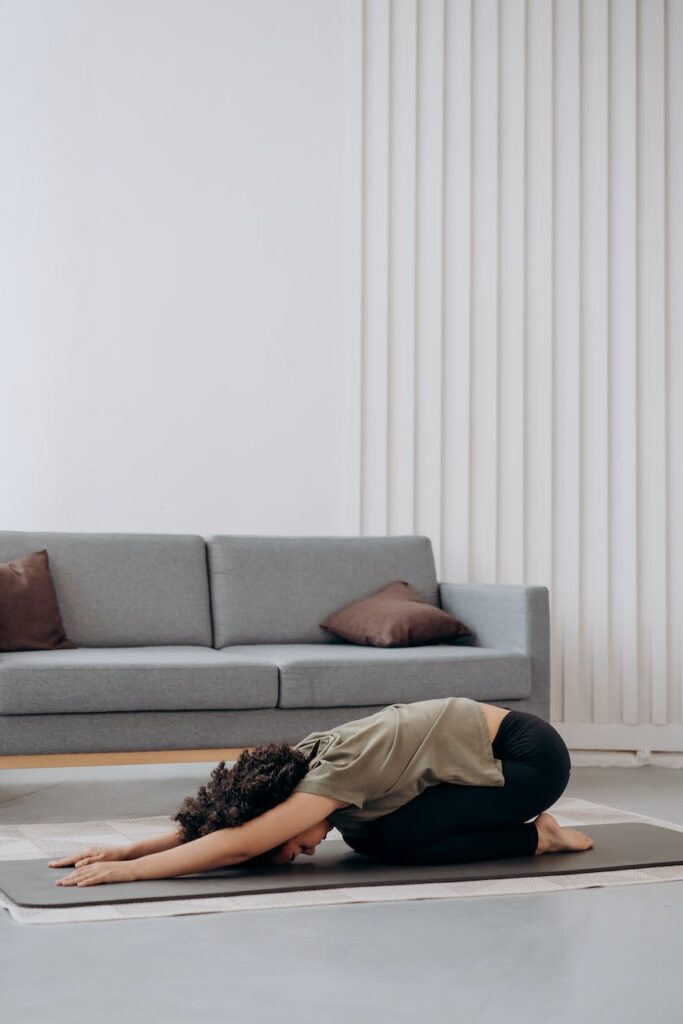 woman in brown shirt in a bending position