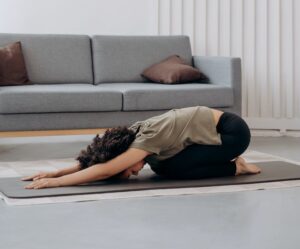 woman in brown shirt in a bending position